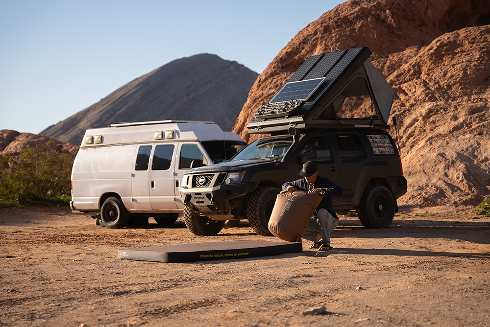 Inflating camping mattress on the road